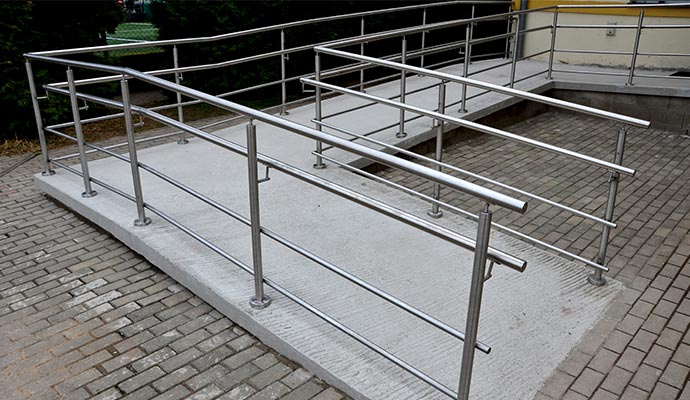 An installed stainless steel ADA ramp