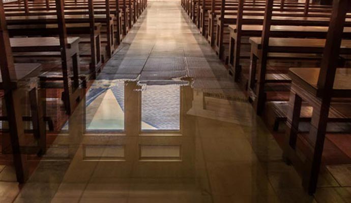 Flooded church interior showing water on the wooden floor