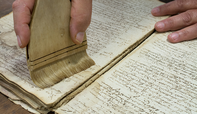 Professional worker restoring damaged documents