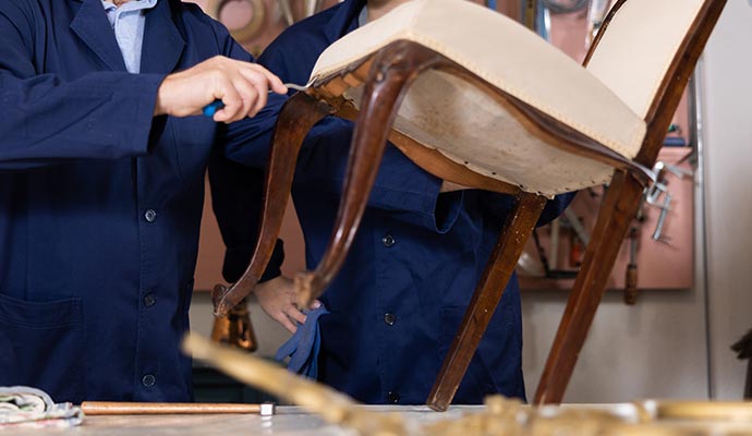 Skilled workers restoring damaged furniture