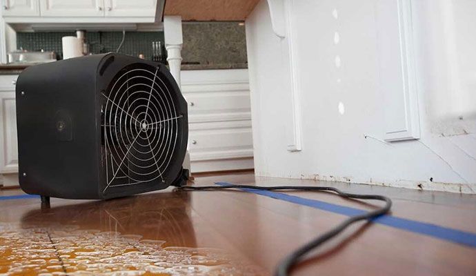 Industrial air movers drying a wet floor