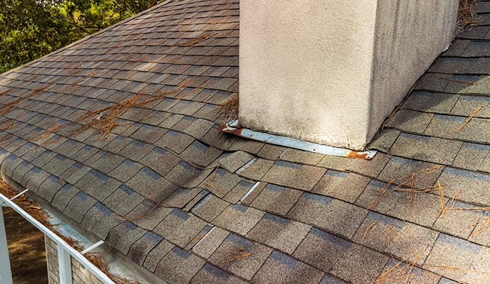 A damaged roof with chimney