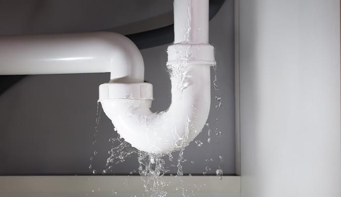 Water dripping and pooling from leaky pipe